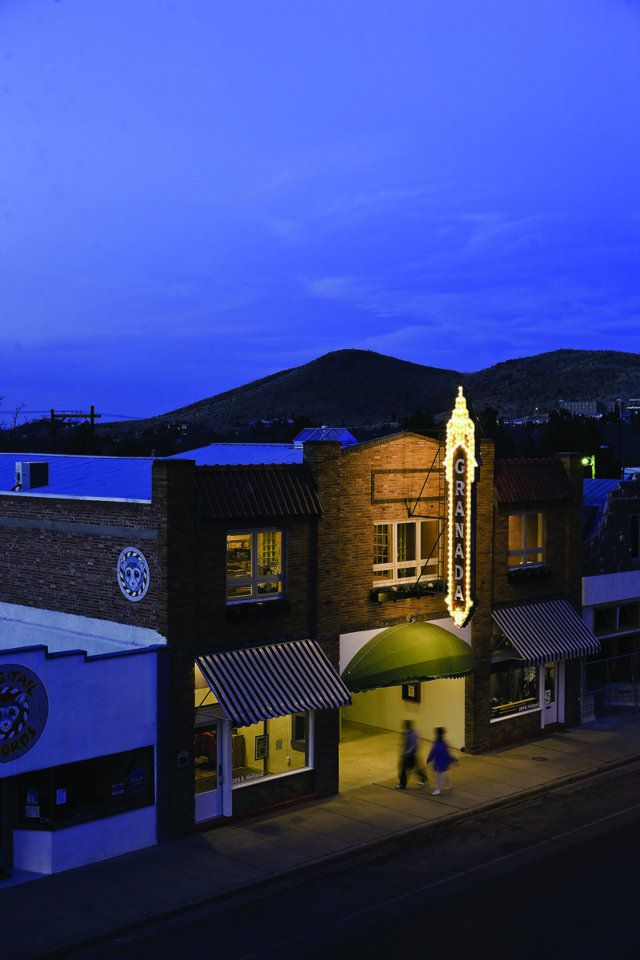 Modern Granada Theatre at dusk with illuminated sign